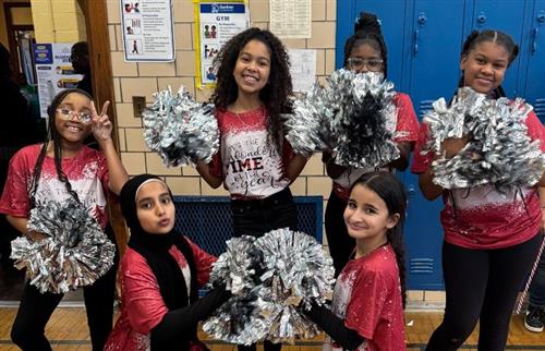 students posing with pom poms 
